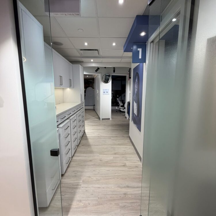 Glass doors opening into the clinical area and treatment rooms at Smili Dental