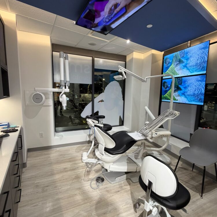 Modern dental treatment room with a ceiling-mounted TV for patients at Smili Dental North Vancouver