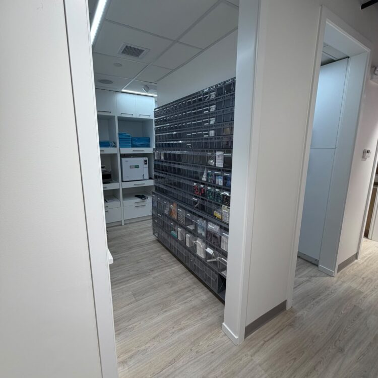 Sterilization room with autoclave and labelled instrument storage bins at Smili Dental